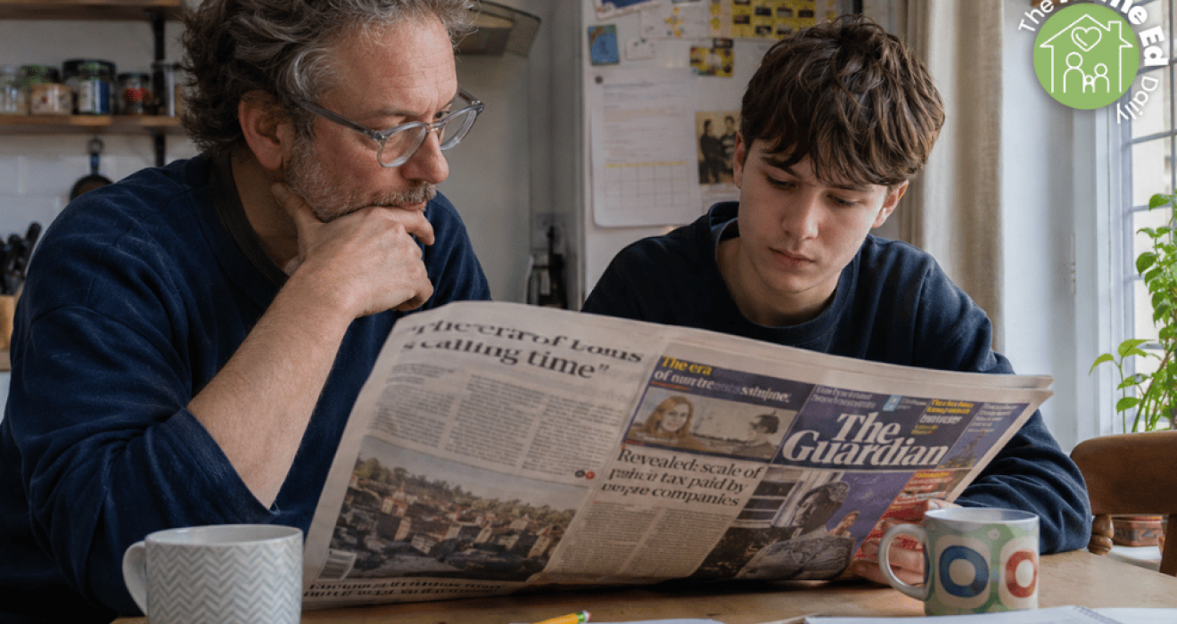 Parent and child sitting together at a kitchen table reading a newspaper. The Home Ed Daily
