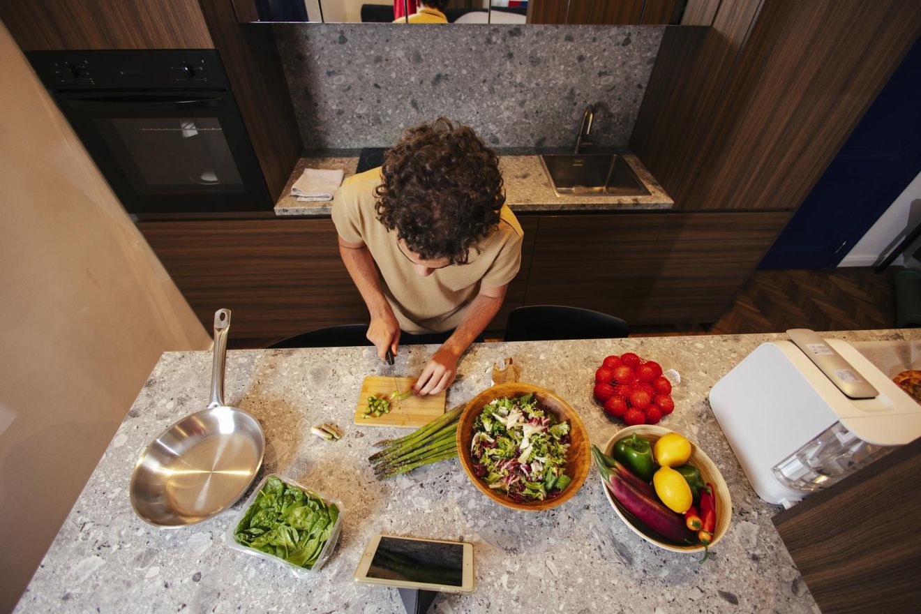 Teenager preparing food at home while learning practical cooking and independent living skills